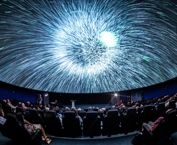 Planetarium photo showing an audience looking at stars on the screen