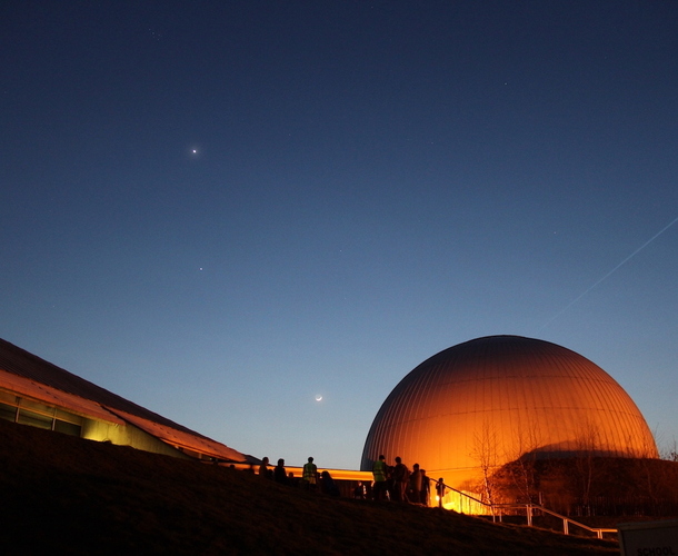The Planetarium lit up against the night sky