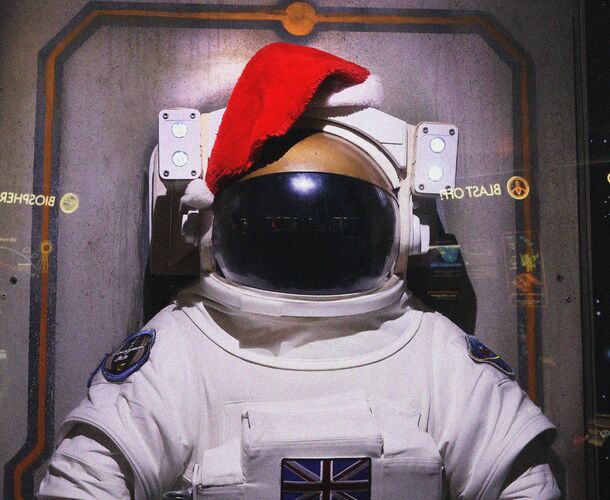 A spacesuit with a Santa hat on it's helmet