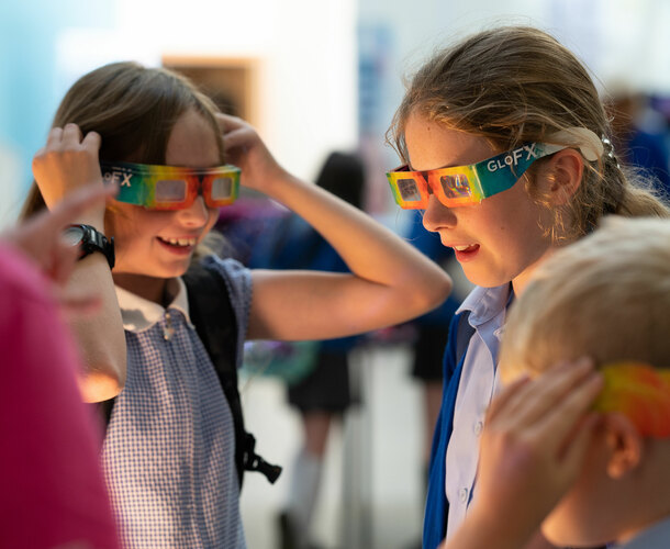 Two girls wearing science refraction glasses