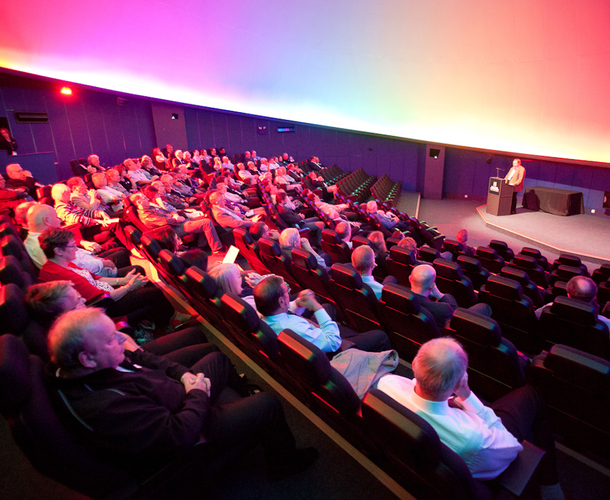Planetarium photo showing an audience sitting in the auditorium listening to a speaker at the front