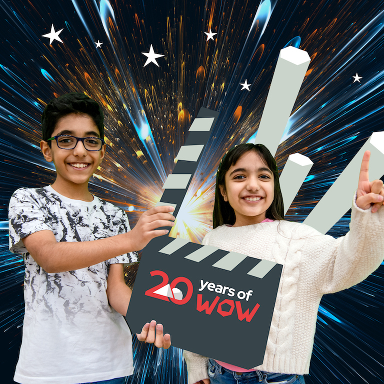 Science show promotional image showing a boy holding a clackerboard and a girl smiling with her hand in the air
