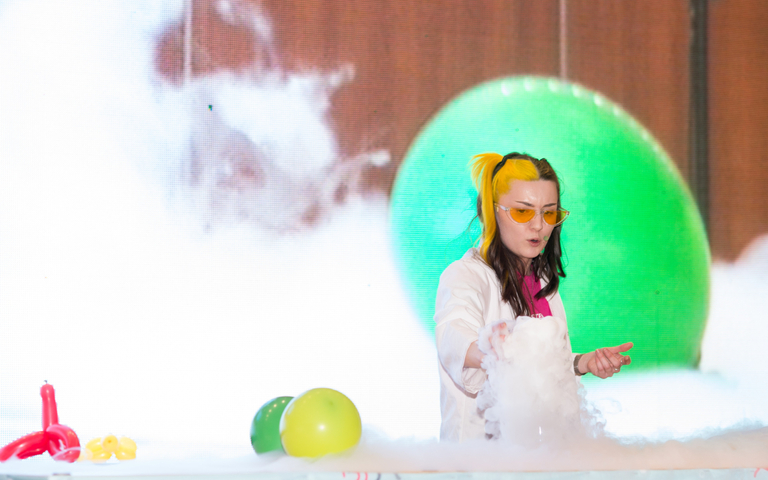A science communictaor conducts and experiment with lots of smoke