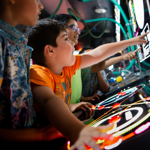 A child points at a Science centre exhibit with excitement