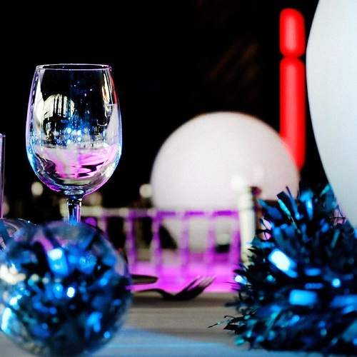 A wine glass on a festive dinner table