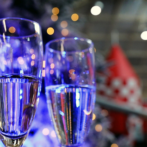 Champagne glasses with a red rocket behind them