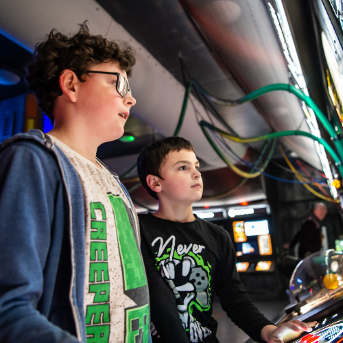Two boys play with interactive space exhibits at Winchester Science Centre