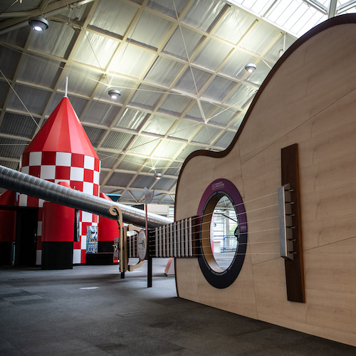 Interactive science exhibition photo showing the giant guitar and sonic rocket