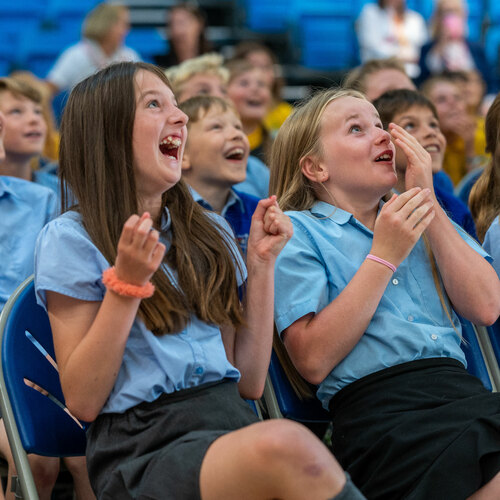 Two girls are amazed by something off camera