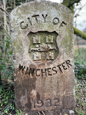 A stone mile marker that says 'City of Winchester'