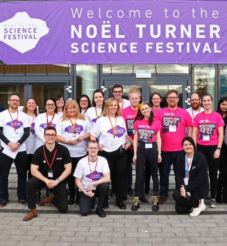 A group of staff and volunteers in Noel Turner Science Festival t-shirts